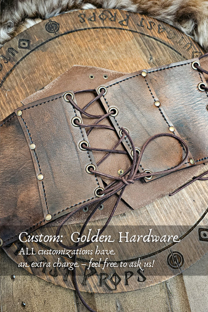 Back view of aged brown leather corset featuring custom golden brass rivets and eyelets, hand-laced with leather cords for adjustable fit. Designed for witches, alchemists, and steampunk adventurers, this custom LARP corset option adds warmth and elegance to renaissance fair clothing or fantasy outfits. Each piece is handmade from full-grain vegetable-tanned leather using eco-friendly dyes and aging techniques.