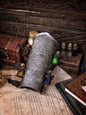 A leather bracer with metal rivets and straps, featuring intricate alchemical circles and small glass vials for storing liquids. Alchemist leather bracer with transmutation circle larp armor Wizards sorcerers and masters of the occult and the arcane