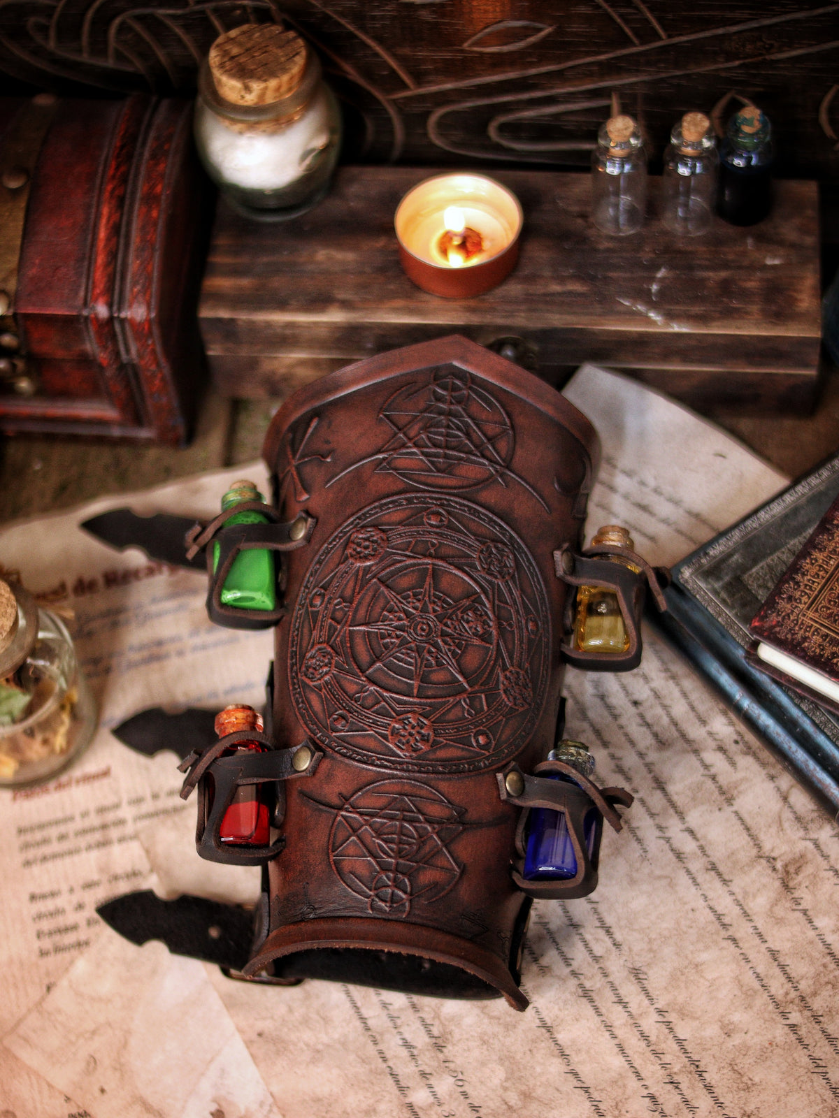 A leather bracer with metal rivets and straps, featuring intricate alchemical circles and small glass vials for storing liquids. Alchemist leather bracer with transmutation circle larp armor Wizards sorcerers and masters of the occult and the arcane
