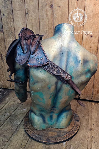 Barbarian Viking Leather Shoulder armor set. Mannequin torso with a leather saddle on a wooden background