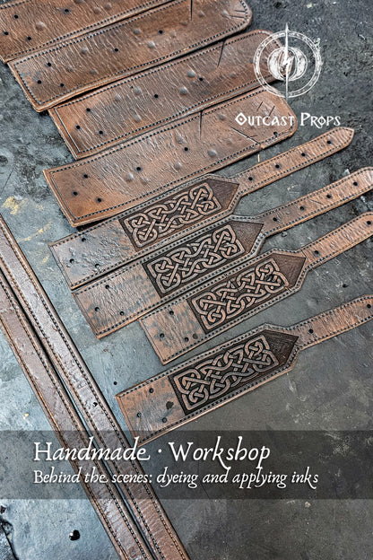 Barbarian Viking Leather Shoulder armor set. Set of leather straps with intricate designs on a textured surface, featuring Outcast Props branding.
