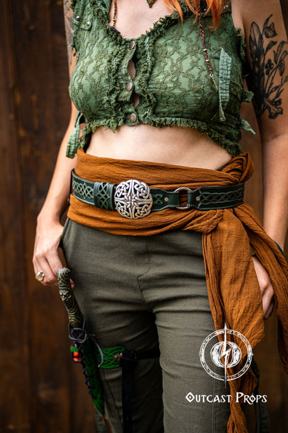Person wearing a green lace top, brown sash, and green pants with a belt buckle. Celtic knot leather belt silver buckle larp belt for ren fair fantasy costume celtic belt unisex leather belt for renaissance outfit