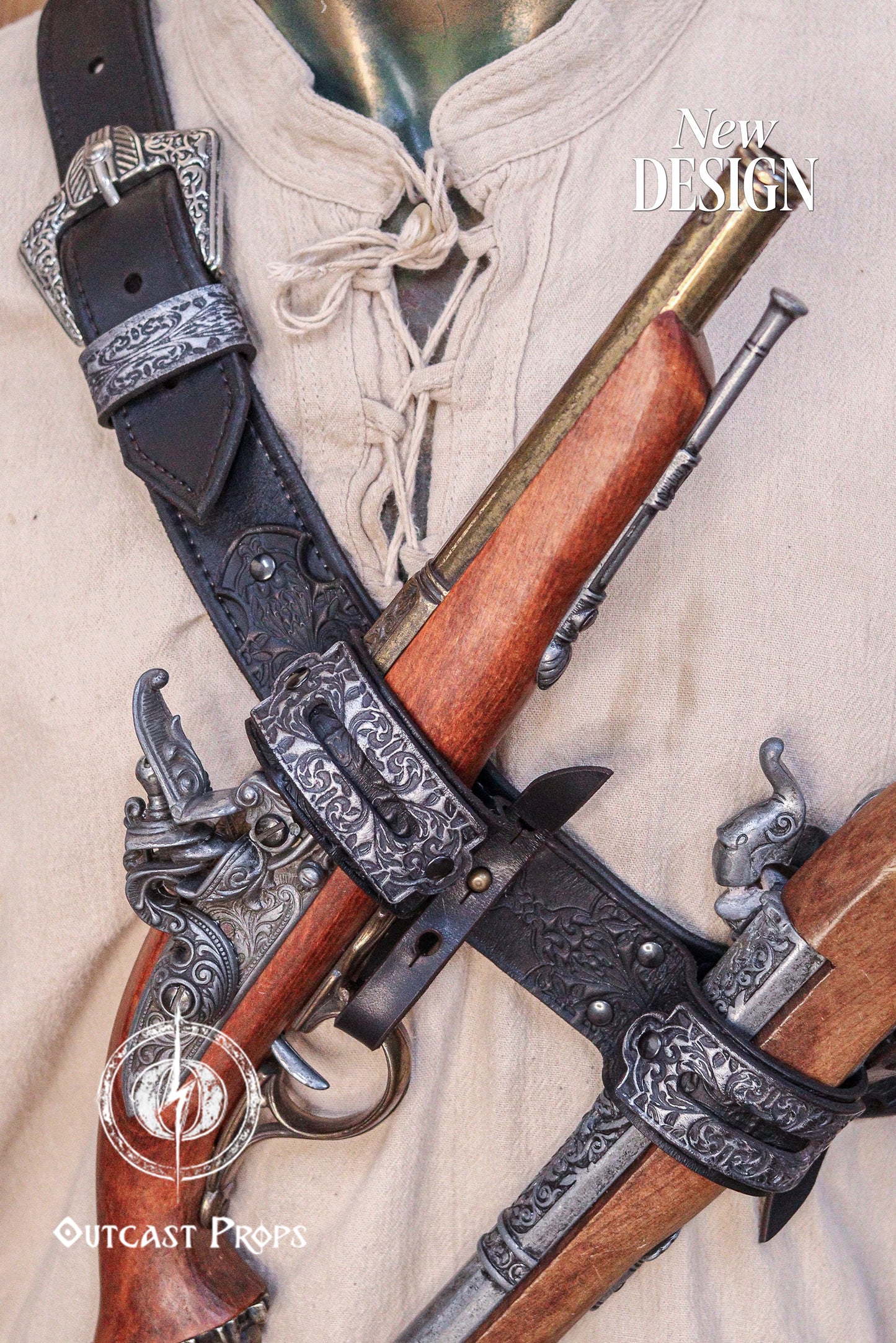Detailed front view of the Edward Kenway leather baldric holding two replica flintlock pistols. The belt’s engraved metal clips and buckle stand out against the off-white linen shirt. This pirate cosplay accessory, perfect for LARP and Edward Kenway costumes, showcases artisan floral embossing and Outcast Props’ signature aging technique, creating a cinematic look straight out of the Caribbean.