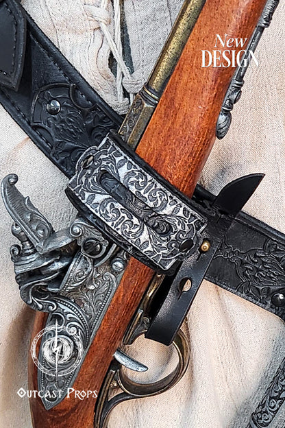 Close-up of the flintlock pistol secured in the Edward Kenway leather baldric. The engraved metallic holder hugs the wooden barrel with precision, while the black leather strap behind showcases floral embossing and rivet details. A must-have for fans of pirate-themed cosplay, LARP warriors, and Assassin’s Creed Edward Kenway costume builds.