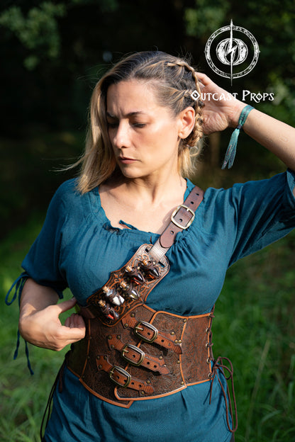 Woman wearing a brown leather corset with metal buckles outdoors. Embroidered Leather Underbust Corset – Elegant Brown Waist Cincher for Noble LARP Outfits, Steampunk and Fantasy Glamour
