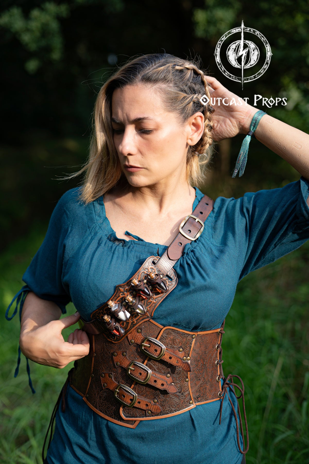 Woman wearing a brown leather corset with metal buckles outdoors. Embroidered Leather Underbust Corset – Elegant Brown Waist Cincher for Noble LARP Outfits, Steampunk and Fantasy Glamour