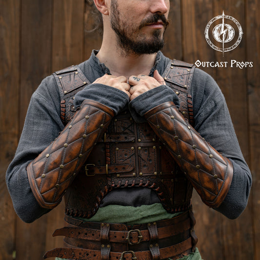 Falken leather bracers for noble costume LARP outfit medieval fantasy accessories for Ren Faire cosplay arm guards for knight character gear. Person wearing a detailed leather armor with 'Outcast Props' logo in the corner.