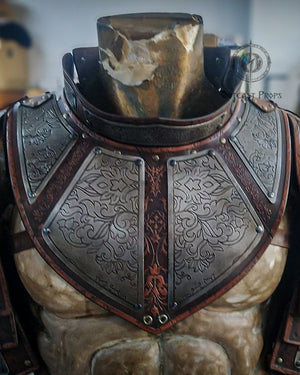 Side view of the articulated leather and engraved metal pauldron