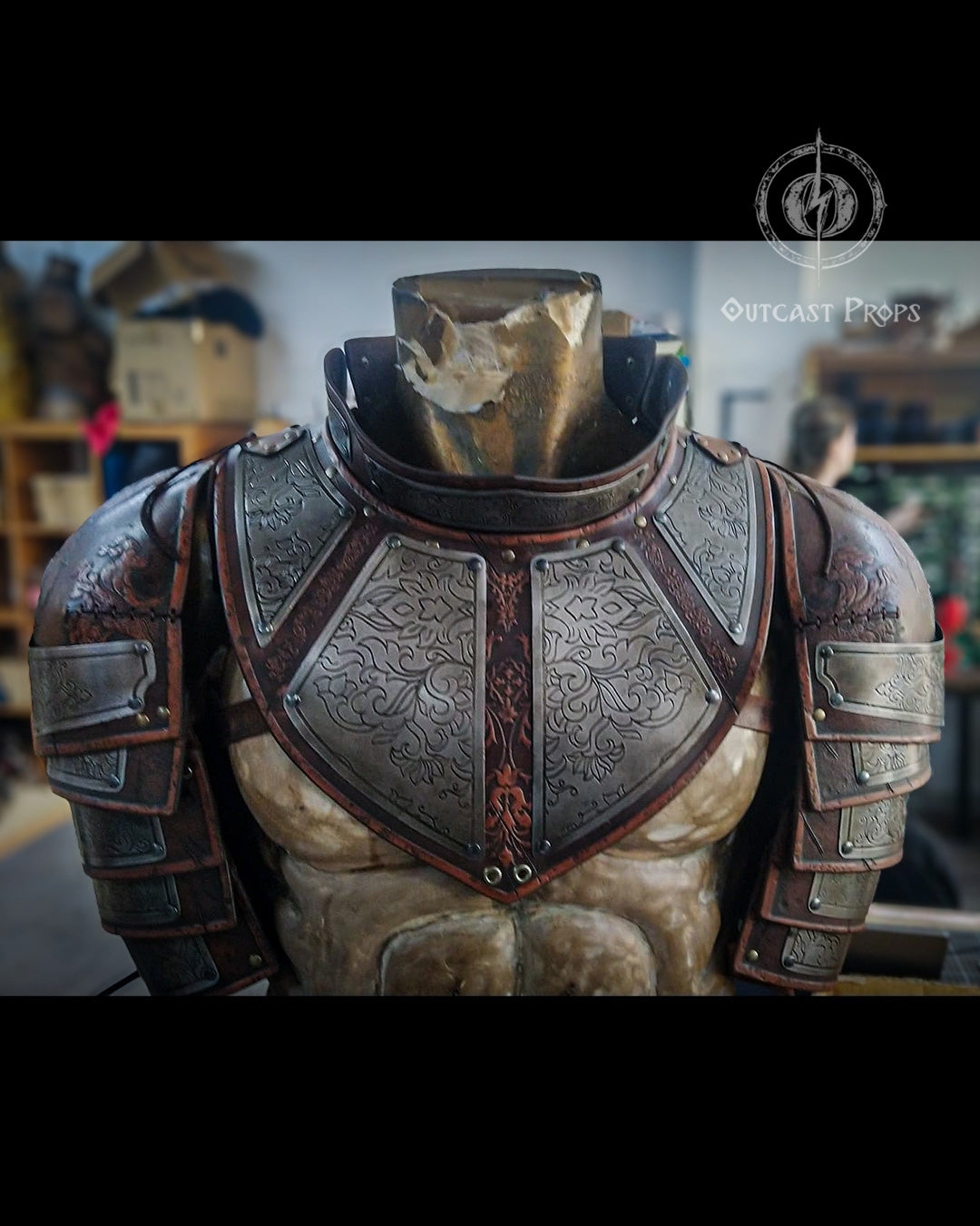 Individual pauldron showing its layered engraved metal sections
