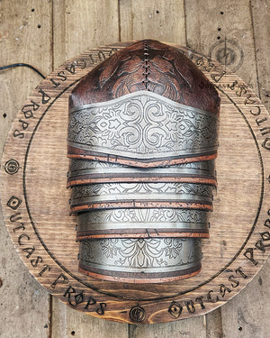 Engraved metal gorget and tooled leather pauldron detail