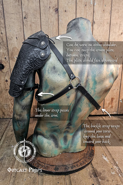 Armored shoulder piece with instructions on how to wear it, displayed on a wooden background. Leather Shoulder Pauldron: Musketeer Armor for LARP, Renaissance LARP, cosplay, Ren Faire accessory, Aramis inspired