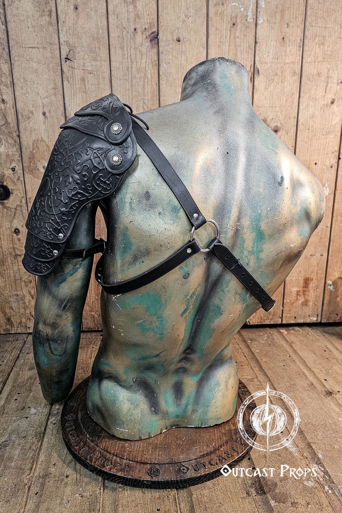 Leather arm guard on a mannequin bust against a wooden background. Leather Shoulder Pauldron: Musketeer Armor for LARP, Renaissance LARP, cosplay, Ren Faire accessory, Aramis inspired