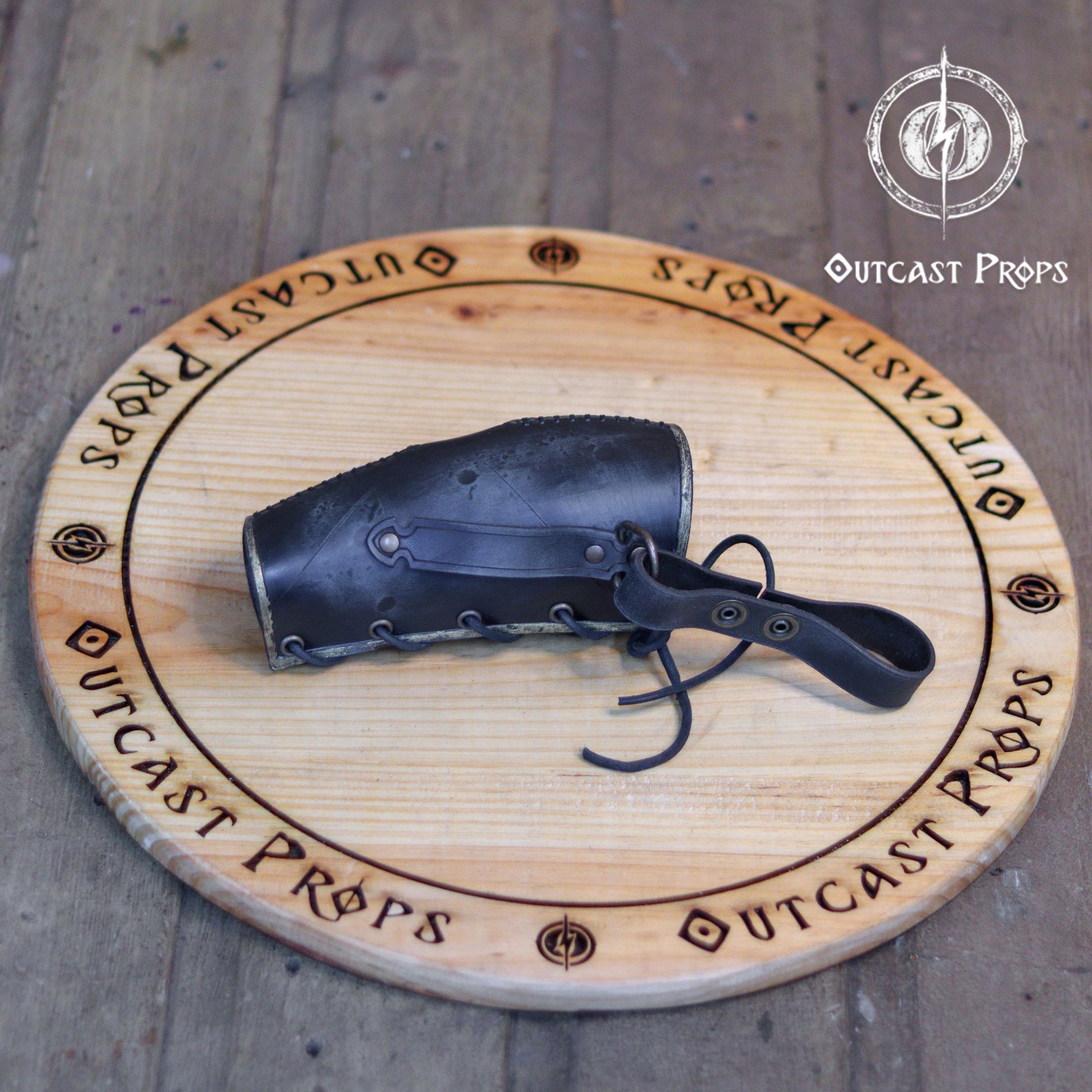 Odin Horns holder, viking horn holder made of leather belt horn holder. Decorative horn on a wooden board with 'Outcast Props' branding.