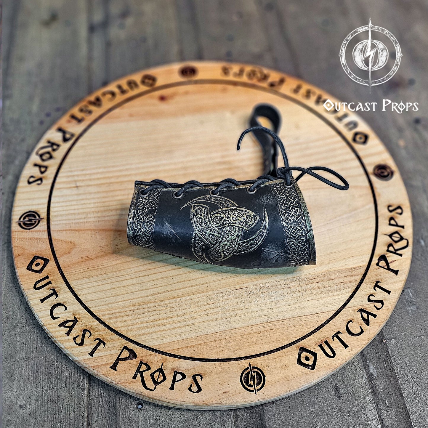 Odin Horns holder, viking horn holder made of leather belt horn holder. Decorative horn on a wooden board with 'Outcast Props' branding.