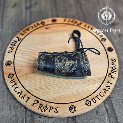 Odin Horns holder, viking horn holder made of leather belt horn holder. Decorative horn on a wooden board with 'Outcast Props' branding.