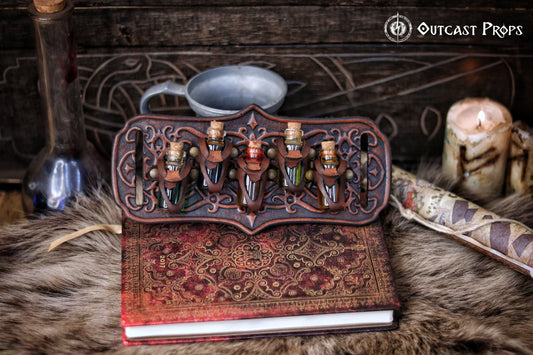 A handmade leather potion holder with ornate embossed patterns, designed to hold five small glass vials. The holder is displayed on a furry surface, and the vials have cork stoppers. Ornated Belt potion holder | 5  potion Belt carrier | LARP, cosplay, fantasy alchemist accessory, adventurers, steampunk, alchemist, healers