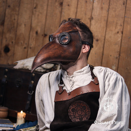 Angled side-front photo of a mannequin wearing the plague doctor mask in brown vegetable-tanned leather. The detailed stitching runs along the beak, and the adjustable strap is visible on the side. Aged leather texture and theatrical design make it perfect for plague mask cosplay, gothic costumes, steampunk LARP, or dark academic aesthetics.