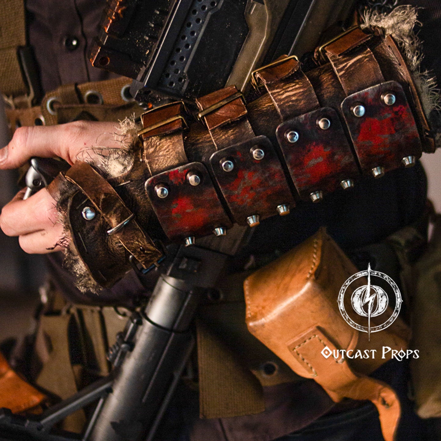 Detailed close-up of the leather bracer with red-black panels, distressed leather straps, and steel rivets. A gritty costume prop for LARP warriors, fantasy fighters, or post-apocalyptic characters. Paired with utility pouches and tactical gear, it brings a high level of authenticity to survivalist and raider roles in themed events or immersive cosplay scenarios. Dystopian Leather & Steel Bracer: Post-Apocalyptic Arm Guard for Wasteland Cosplay and LARP