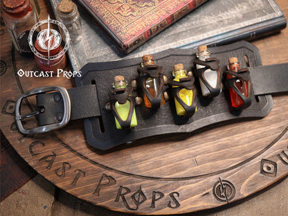 Belt with small bottles and 'Outcast Props' branding on a wooden surface. Belt Potion holder for 5 small bottles. Made of leather for adventurers, steampunk, alchemist, healers, cosplay or just to keep spices