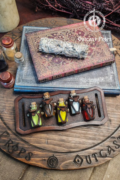 Smoked sage bundle on an old book with 'Outcast Props' branding, surrounded by small bottles. Belt Potion holder for 5 small bottles. Made of leather for adventurers, steampunk, alchemist, healers, cosplay or just to keep spices