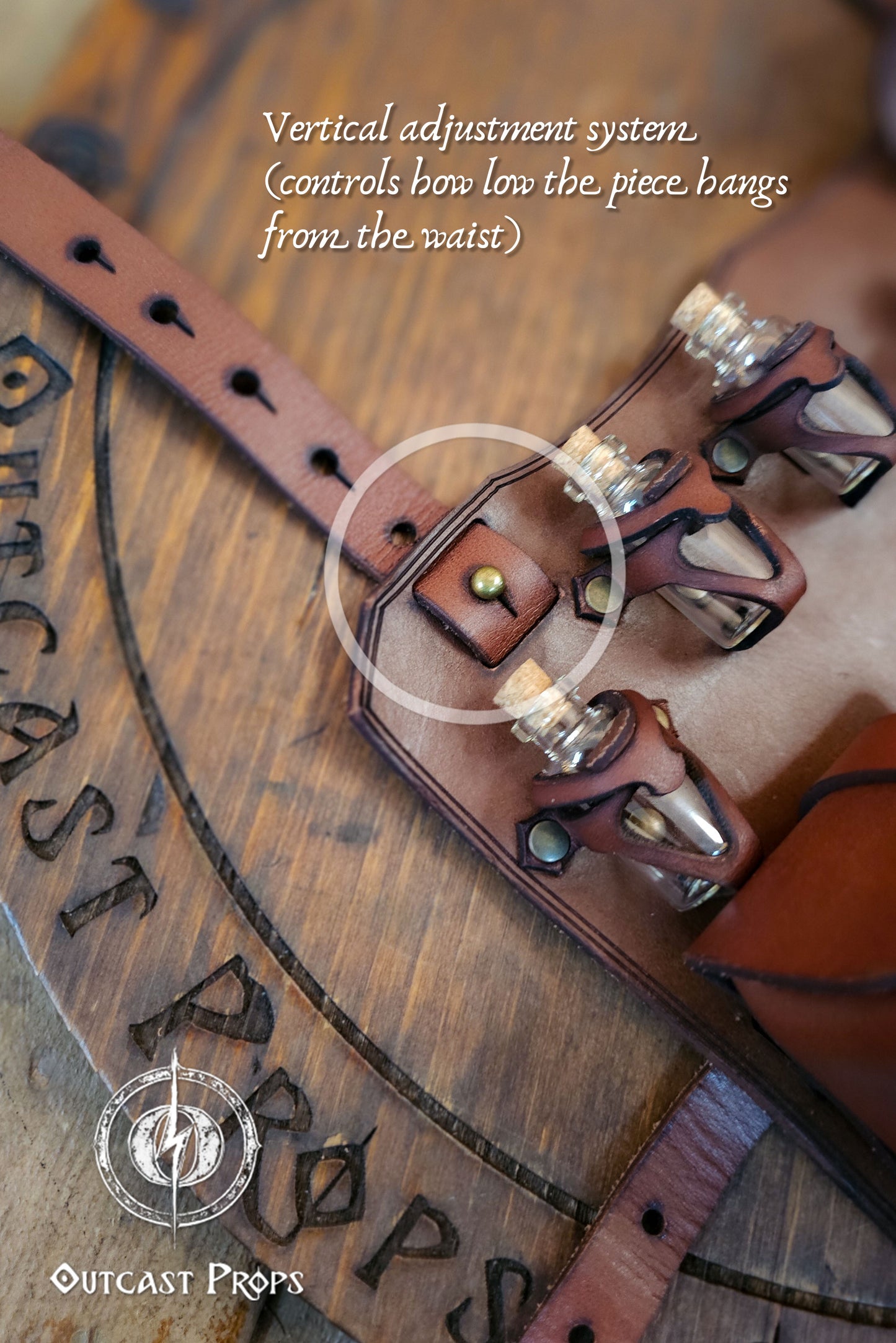 Close-up of the brown leather leg holster showing the vertical adjustment system with brass rivet, used to control how low the piece hangs from the waist. Three glass potion vials with cork stoppers are secured in handcrafted holders. Made from premium vegetable-tanned leather by Outcast Props, ideal for rogues and alchemists in LARP, cosplay, or renaissance fair outfits seeking authentic medieval detail.