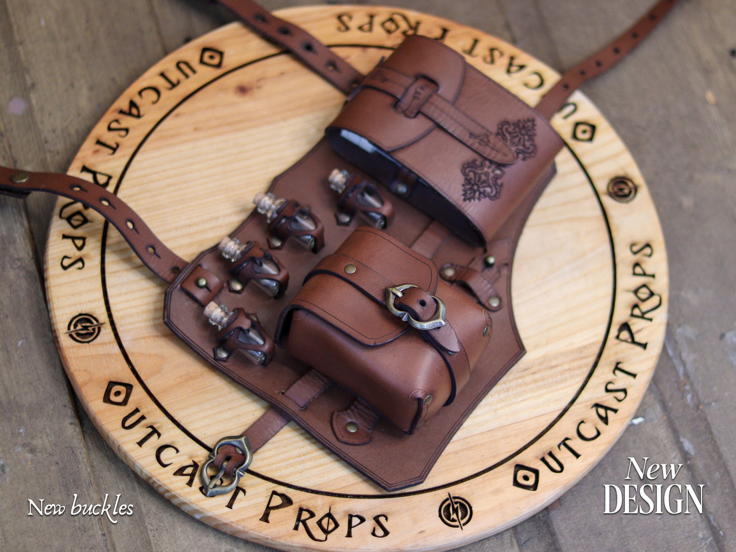 Full view of the new brown leather leg holster design showing upgraded antique brass buckles and reinforced straps. Includes twin pouches, potion vials, and embossed decoration. Handmade by Outcast Props from vegetable-tanned leather, this fantasy alchemist and rogue accessory for LARP, cosplay, and renaissance fairs offers durability, authenticity, and artisan quality inspired by medieval craftsmanship and adventure gear.