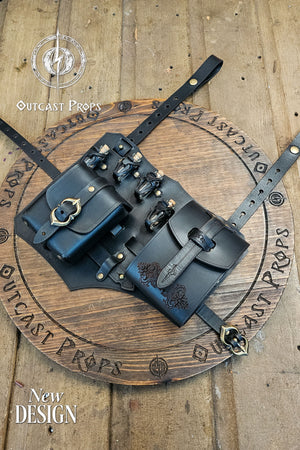 Detailed close-up of the black leather potion holster with two pouches, glass vials, and antique brass hardware. Floral embossing on the larger pouch adds character. Handcrafted by Outcast Props using vegetable tanned leather, hand dyed and aged. Designed for rogues, alchemists, and LARP players, it blends functionality, comfort, and fantasy realism for immersive medieval or cosplay outfits. Adjustable straps keep gear steady. Smooth edges and reinforced rivets add comfort, durability at events.