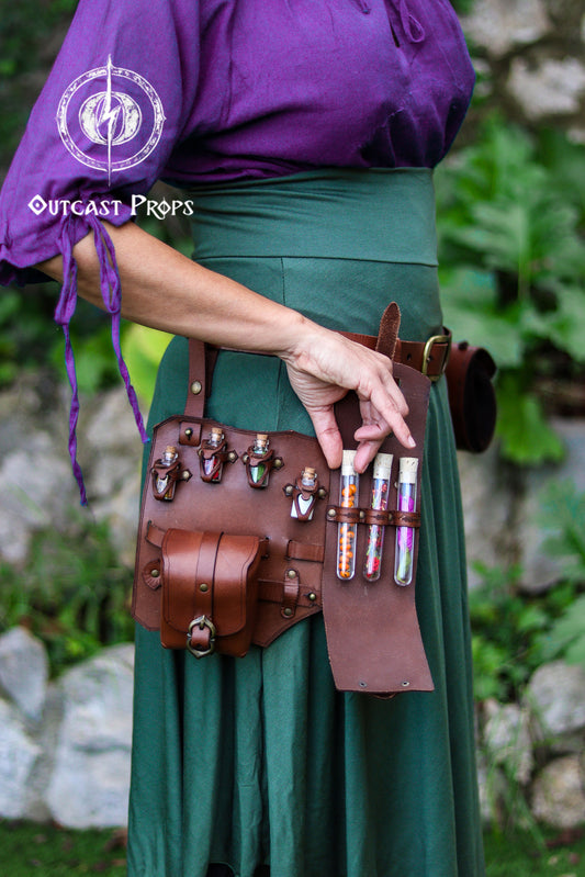 Person wearing a purple top and green skirt with a brown leather belt holding bottles. Leather Leg Harness Potion Holster: Alchemist LARP Steampunk Costume Accessory for Witch Herbologist