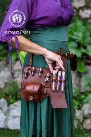 Person wearing a purple top and green skirt with a brown leather belt holding bottles. Leather Leg Harness Potion Holster: Alchemist LARP Steampunk Costume Accessory for Witch Herbologist