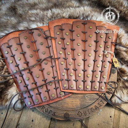 Pair of leather leg guards with metal studs on a fur background. Samurai Leather Greaves for LARP Cosplay or Renaissance Fair Studded Shin Armor Fantasy Warrior Leg Guards Handmade Medieval Costume Piece