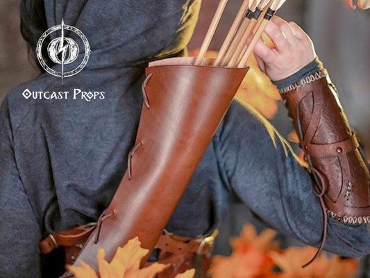 A fantasy leather quiver in rich brown, worn across the back by a hooded figure dressed in medieval garb. Arrows extend upward from the leather arrow quiver. Perfect for larp quiver setups, cosplay archery costumes, or elven quiver ensembles. A great accessory for bow and arrow fans or elf armor enthusiasts. Handmade and dyed, this archery quiver is ideal for immersive fantasy characters.