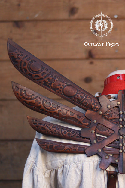 Decorative leather gauntlets with intricate patterns on a wooden background, featuring the Outcast Props logo. Steampunk Wings leather gears fairy victorian outfit burning man aviator pin up costume clock