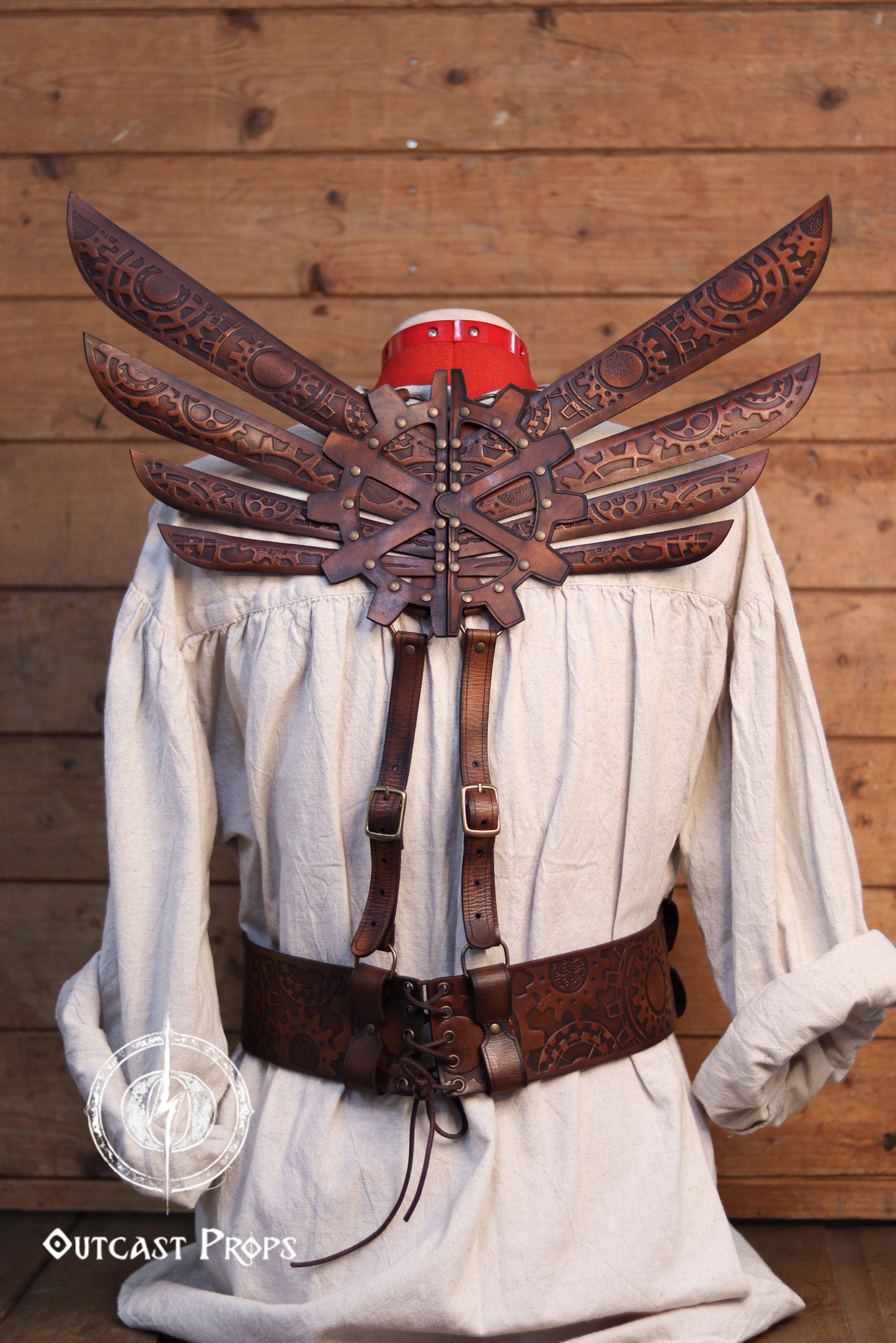 Decorative leather winged backpiece on a mannequin against a wooden. Steampunk Wings leather gears fairy victorian outfit burning man aviator pin up costume clockbackground