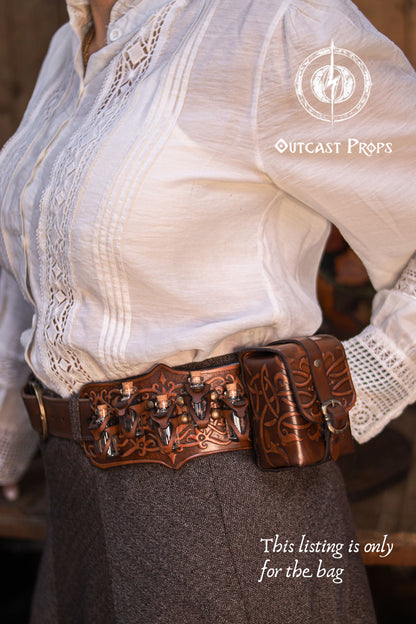 Ornated medieval leather tobacco bag worn alongside other leather belt accessories, showing how it integrates into a complete fantasy belt setup. Made from premium vegetable-tanned leather with embossed decoration, this pouch is ideal for LARP, Renaissance fairs, or everyday carry. A unique handmade leather gift for gamers and fantasy lifestyle lovers.