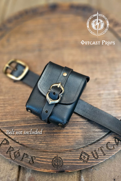 Tavern Small Leather Belt Pouch for Daily Wear LARP Renaissance Fair Viking Cosplay Medieval Accessory Steampunk Coin or Tobacco Pouch. Black leather pouch with gold buckle on a wooden surface, featuring 'Outcast Props' branding.