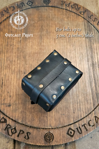 Tavern Small Leather Belt Pouch for Daily Wear LARP Renaissance Fair Viking Cosplay Medieval Accessory Steampunk Coin or Tobacco Pouch. Black leather belt pouch on a wooden surface with Outcast Props branding.