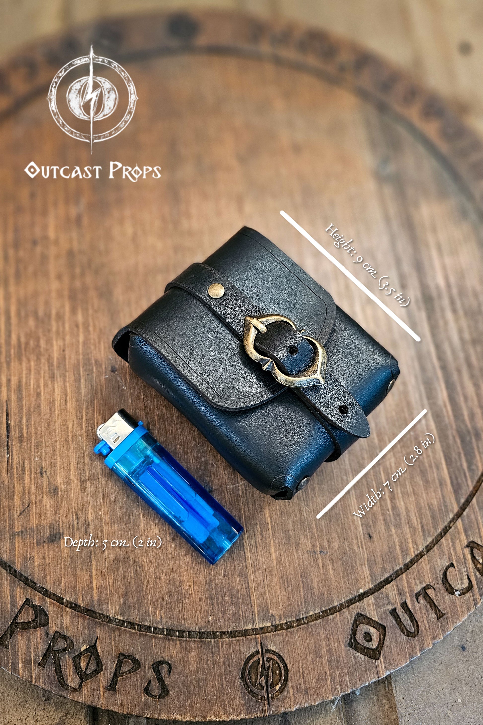 Tavern Small Leather Belt Pouch for Daily Wear LARP Renaissance Fair Viking Cosplay Medieval Accessory Steampunk Coin or Tobacco Pouch. Black leather pouch with gold buckle on a wooden surface, featuring Outcast Props branding.