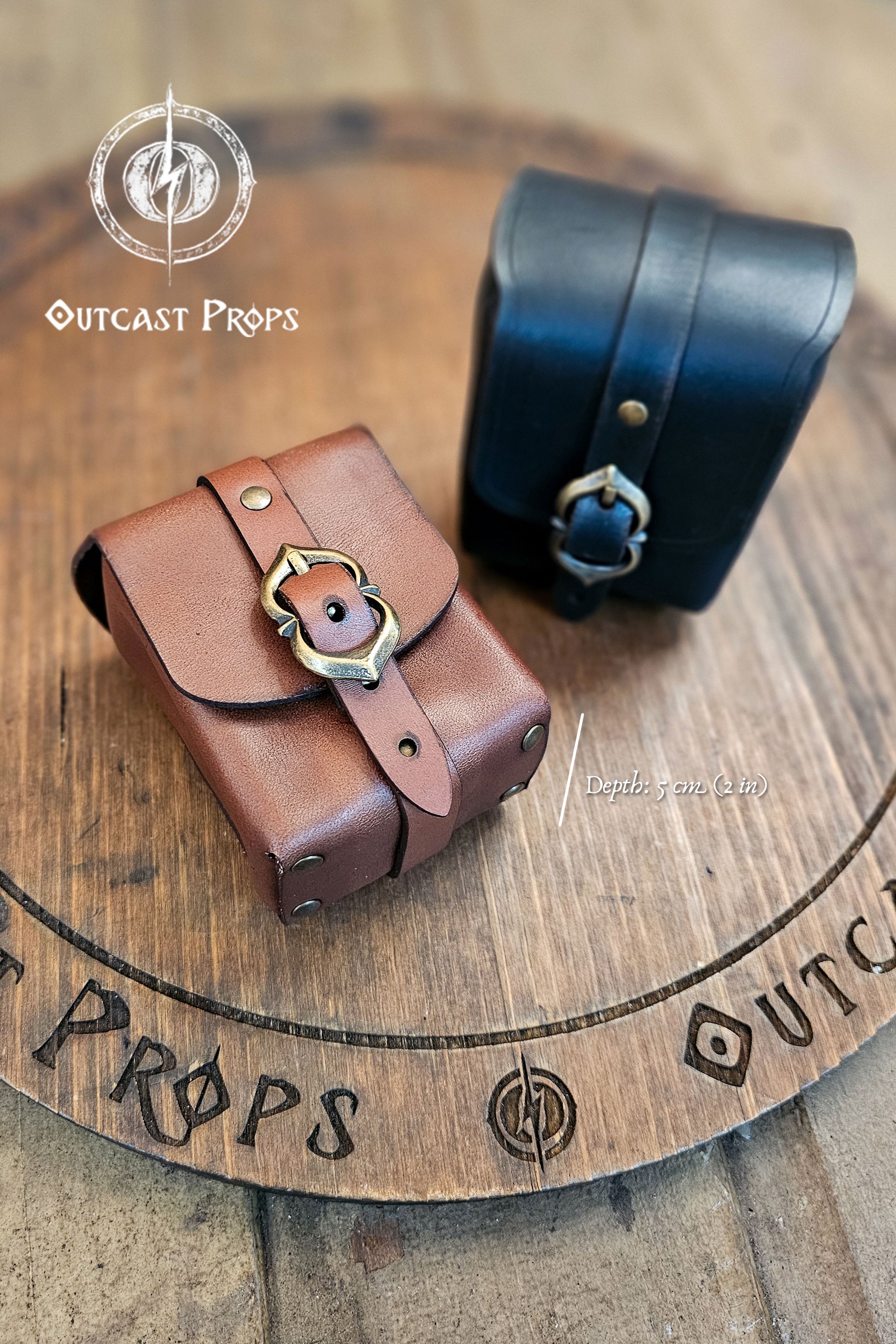 Tavern Small Leather Belt Pouch for Daily Wear LARP Renaissance Fair Viking Cosplay Medieval Accessory Steampunk Coin or Tobacco Pouch. Brown leather pouch with metal buckle on a wooden surface with 'Outcast Props' branding.