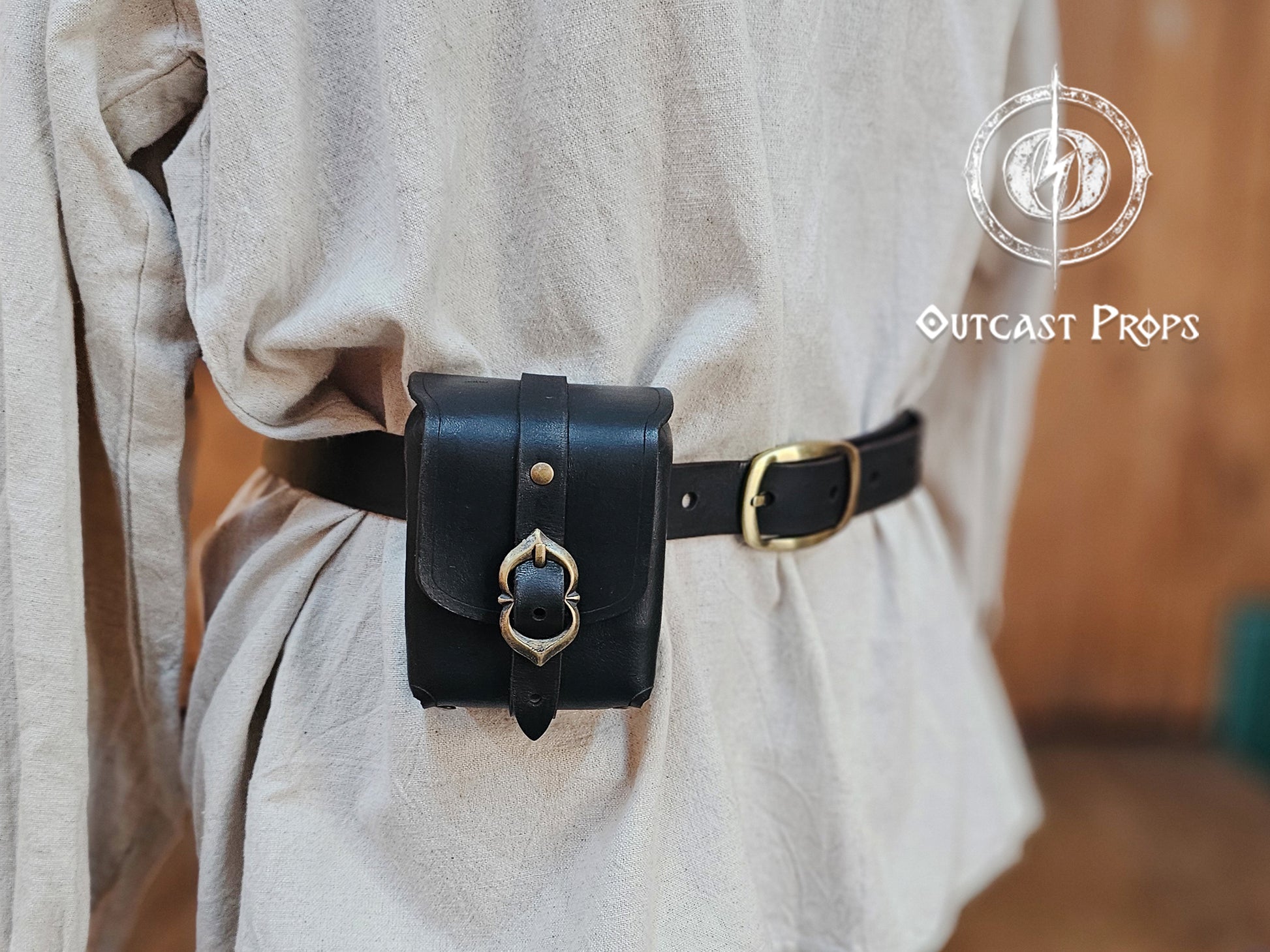 Tavern Small Leather Belt Pouch for Daily Wear LARP Renaissance Fair Viking Cosplay Medieval Accessory Steampunk Coin or Tobacco Pouch. Person wearing a black belt bag with gold buckle on a plain background, branded 'Outcast Props'.
