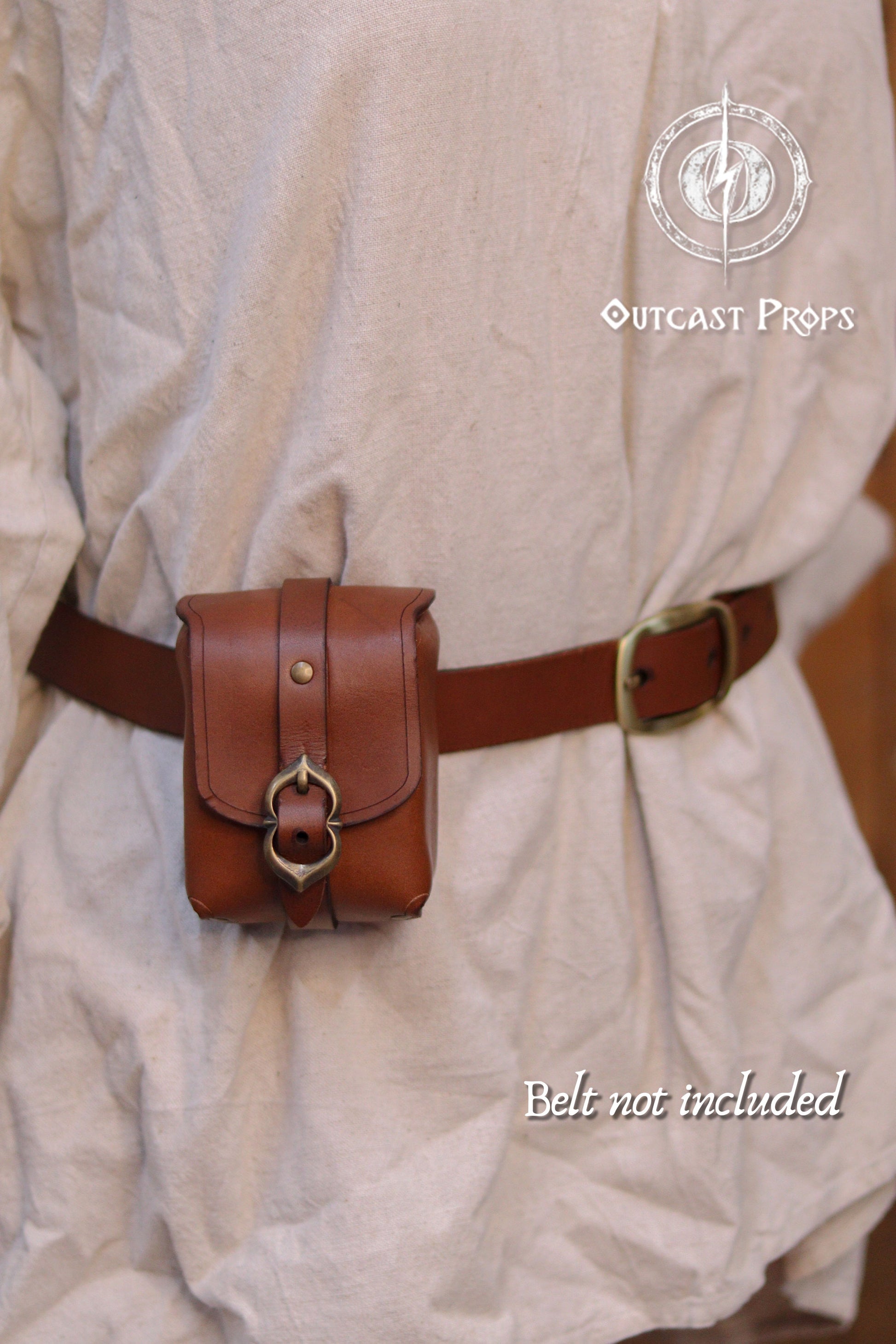 Tavern Small Leather Belt Pouch for Daily Wear LARP Renaissance Fair Viking Cosplay Medieval Accessory Steampunk Coin or Tobacco Pouch. Brown leather pouch with decorative buckle on a person wearing a beige outfit, with 'Outcast Props' branding.
