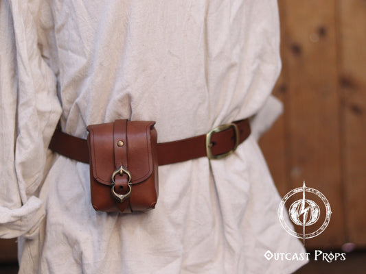 Tavern Small Leather Belt Pouch for Daily Wear LARP Renaissance Fair Viking Cosplay Medieval Accessory Steampunk Coin or Tobacco Pouch. Person wearing a brown belt with a pouch, with 'Outcast Props' logo in the corner.