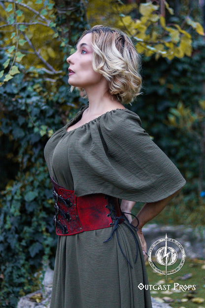 Woman wearing a green dress with a red corset in a natural setting. Elegant Floral Underbust Leather Corset - Handcrafted Rose Design for Larp, Reinassance Faire Cosplay