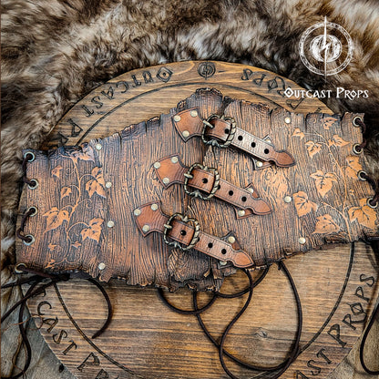 Wooden belt with leather straps on a fur background, featuring 'Outcast Props' branding.  Underbust Wood Leather Corset. Herbalist corset. Druid corset. Elven Corset. Ivy Corset.