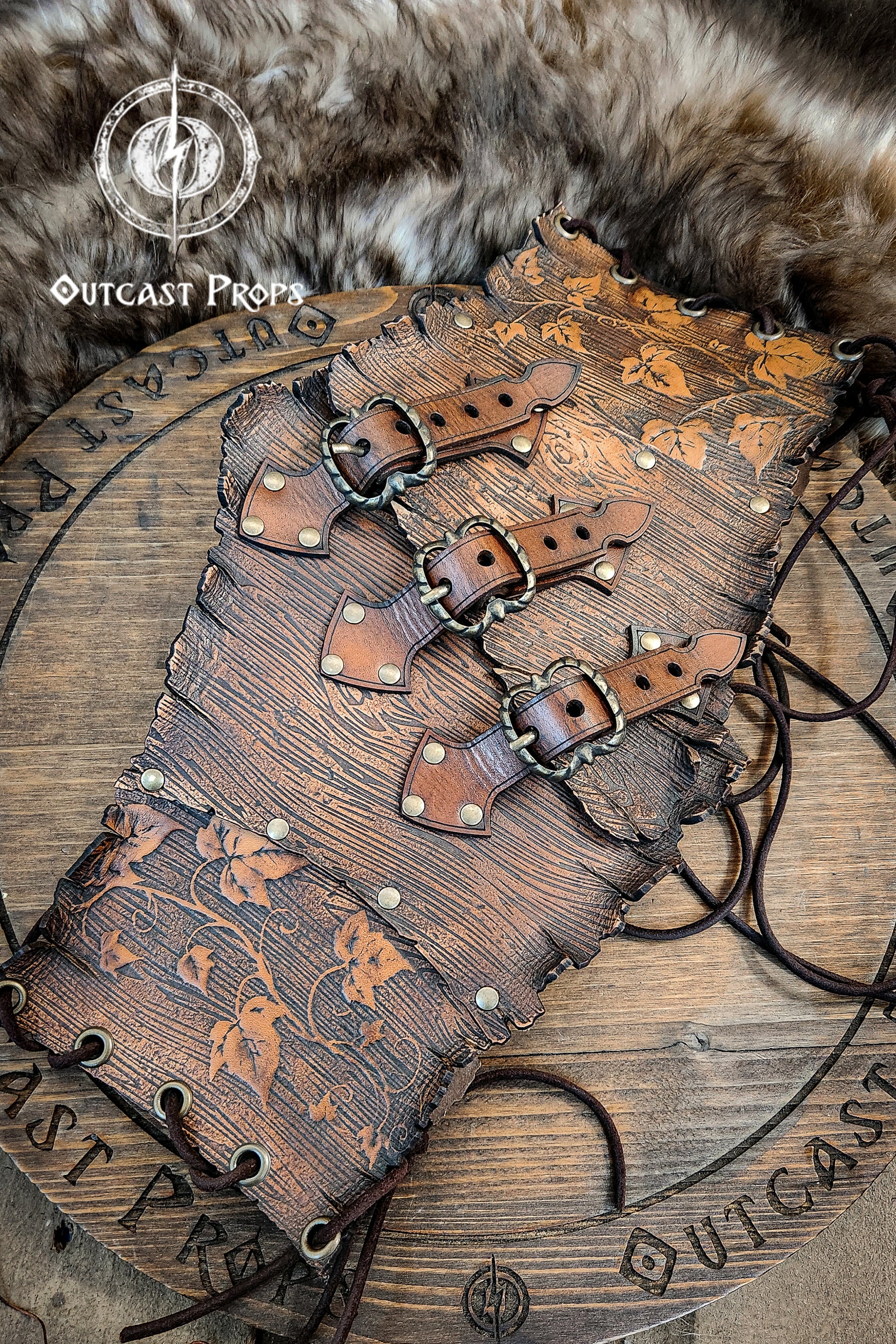 Wooden belt with leather straps on a fur background, featuring 'Outcast Props' branding.  Underbust Wood Leather Corset. Herbalist corset. Druid corset. Elven Corset. Ivy Corset.