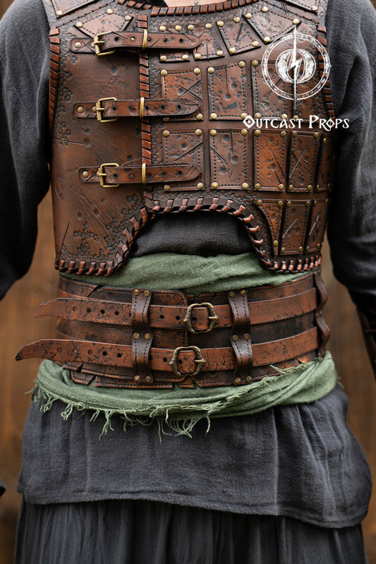 Brown leather vest with gold buckles and Outcast Props branding on a blurred background. Leather Broadbelt in brown leatrher, battle worn, aged. Veteran Leather Belt premium vegetable-tanned, worn by raiders and mercenaries