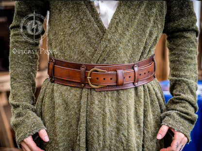 Person wearing a green textured garment with a brown leather belt. Celtic knot leather belt silver buckle larp belt for ren fair fantasy costume celtic belt unisex leather belt for renaissance outfit