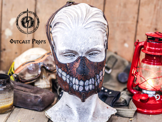 Skull-themed mask on a mannequin head with rustic background and lantern. Zombie Leather Face Mask walking dead bitters, for cosplay or bikers. Can be used with disposable face masks, filters or washable masks