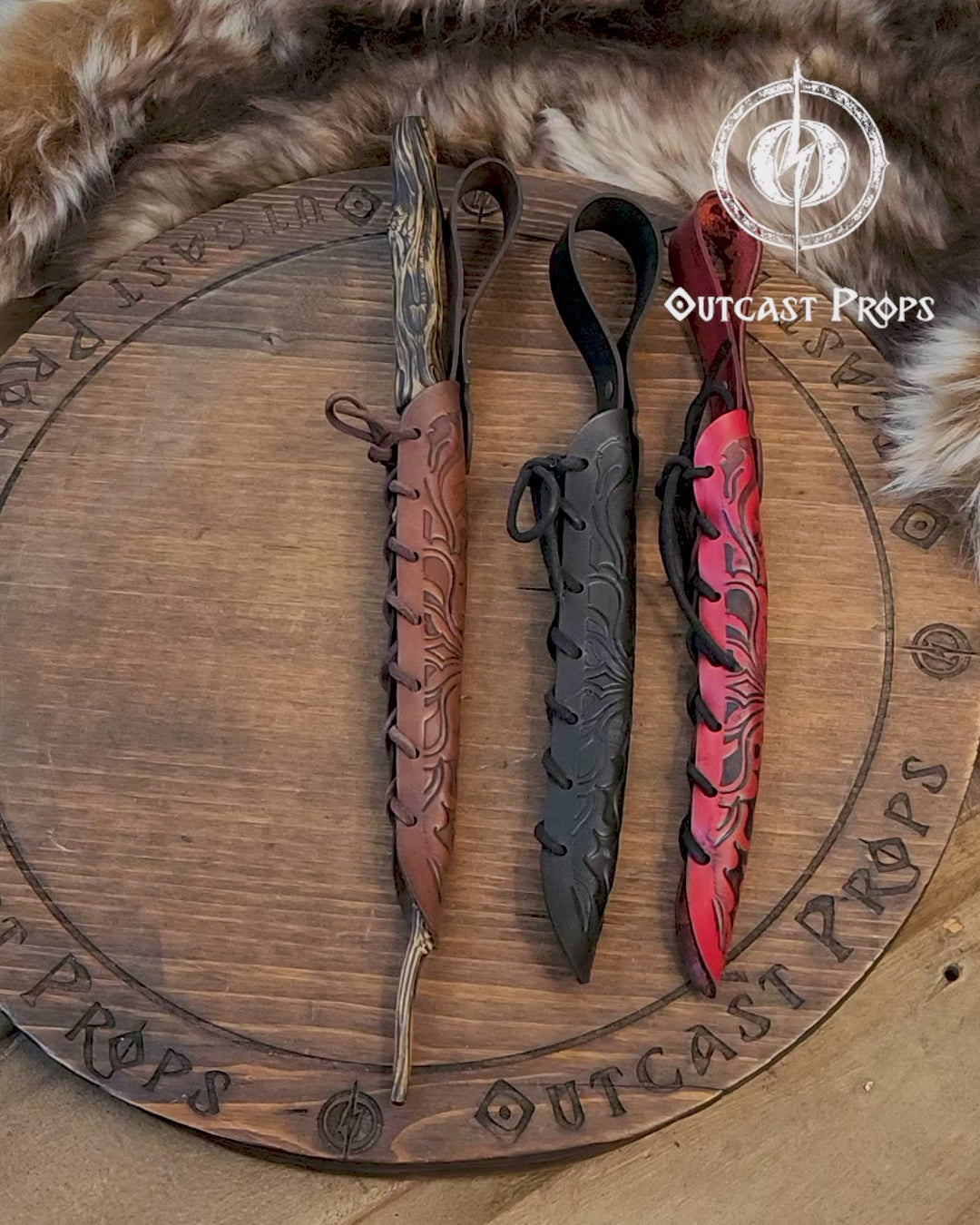 A close-up of an ornate laced leather wand holster displayed on a table with a decorative backdrop, featuring a leather-bound notebook and a candle. Magic Wand leather Holster Ornated Laced & Aged, for wizard and witch costume belt holster LARP and magic conventions and fair events