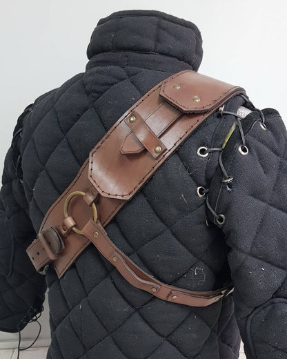 Back view of witcher leather baldric with reinforced shoulder strap and ring system. Crafted for Geralt cosplay, Witcher 3 armor, ursine costume builds, LARP armor and medieval leather gear fans. Ideal monster hunter accessory for immersive roleplay.